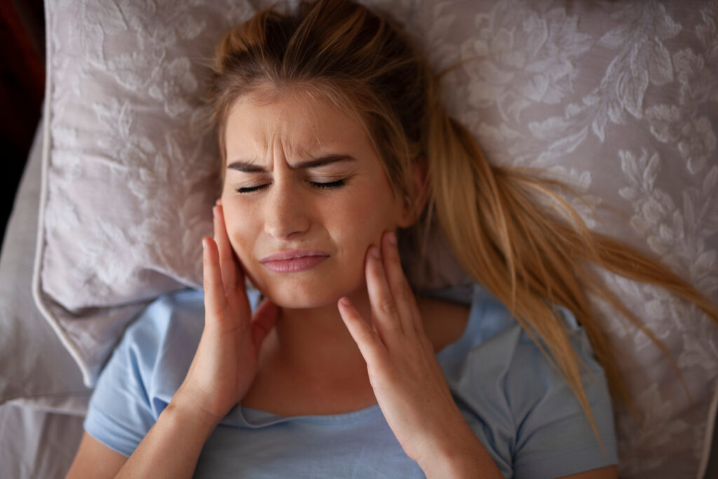 Dental emergency – woman holding her face in pain from toothache